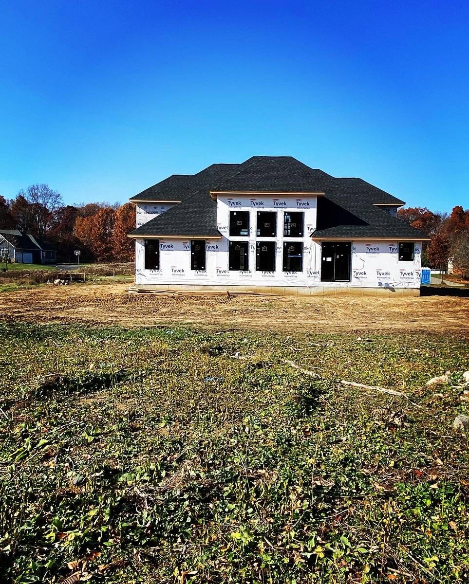 Custom home exterior during framing and structural enclosure stage