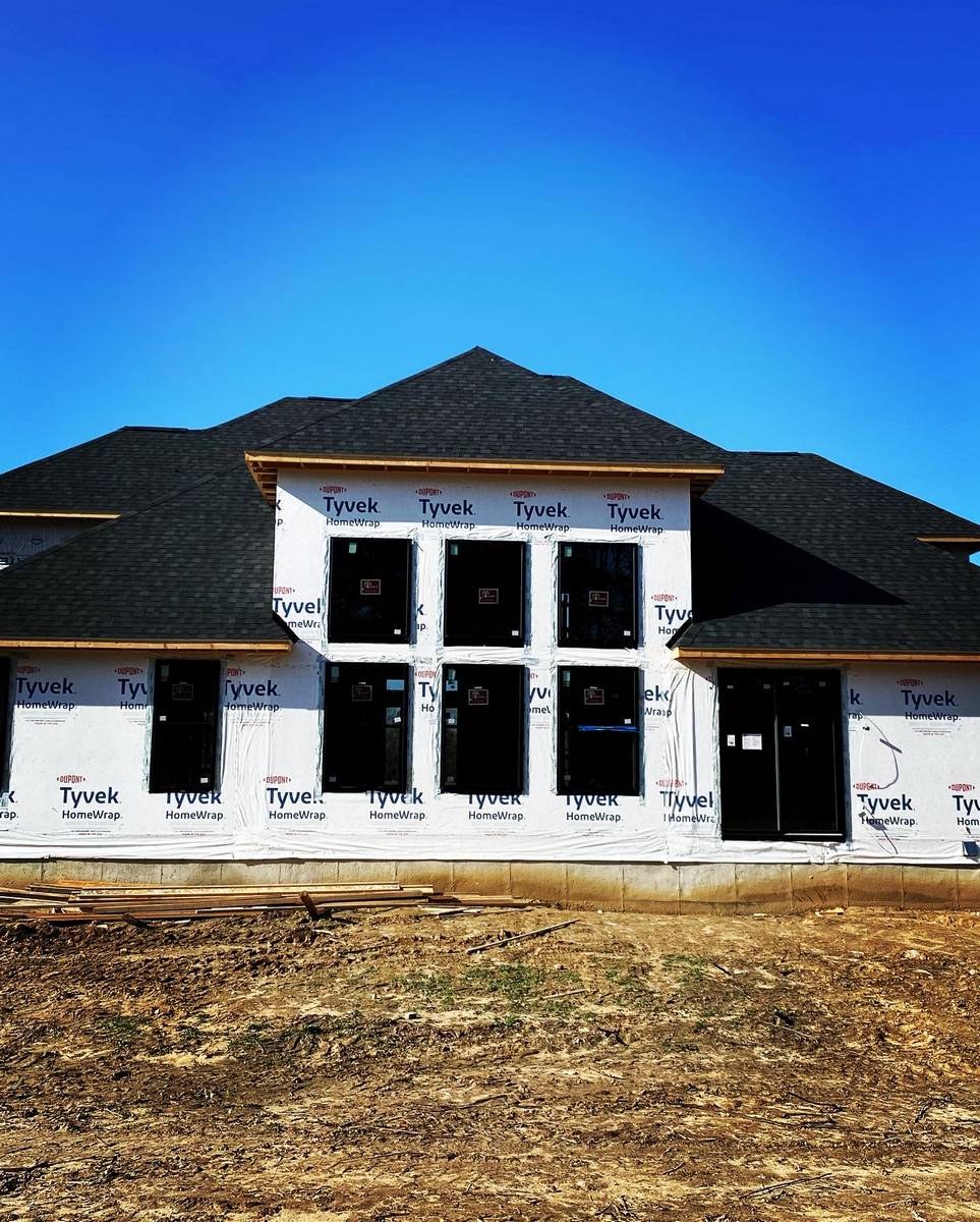 Custom home build showing exterior structure at active construction stage