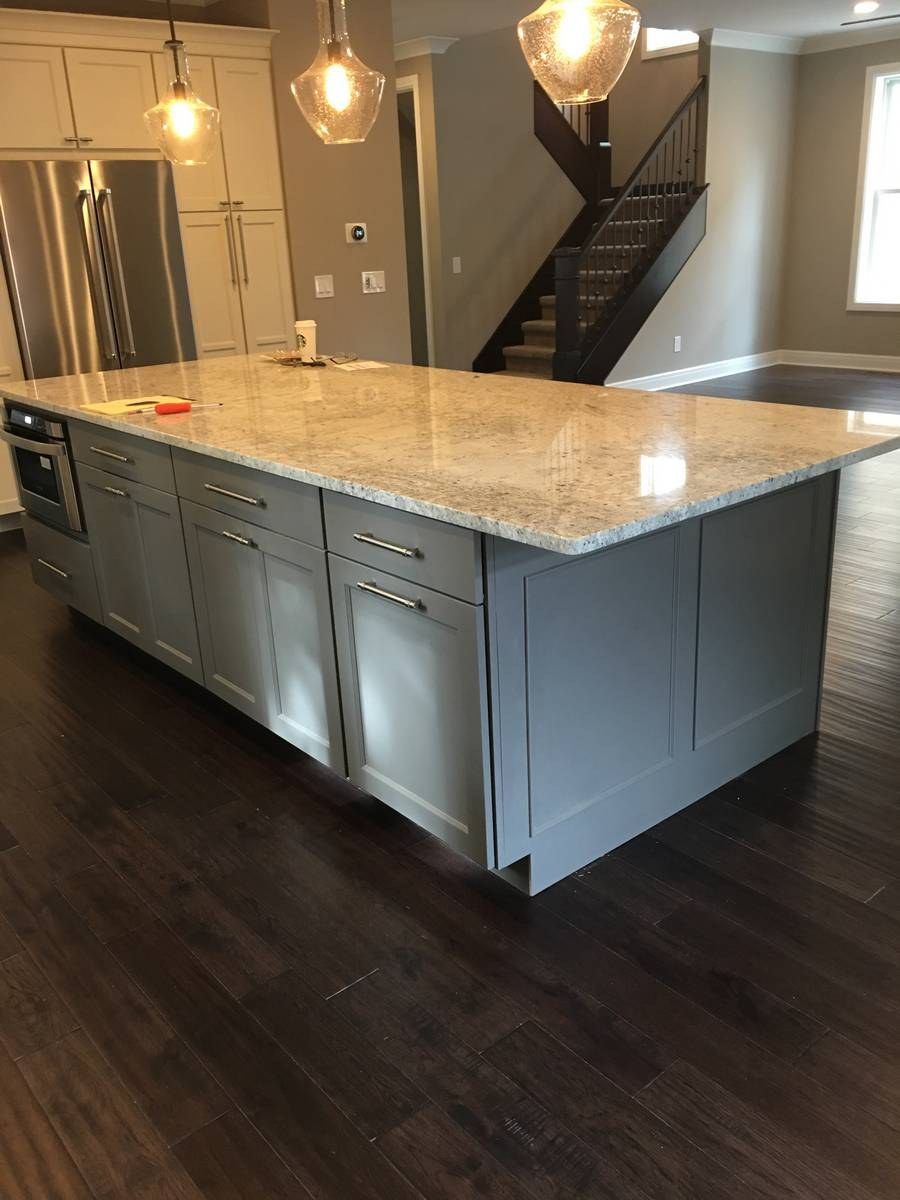 Kitchen renovation with white shaker cabinets and premium stone countertops
