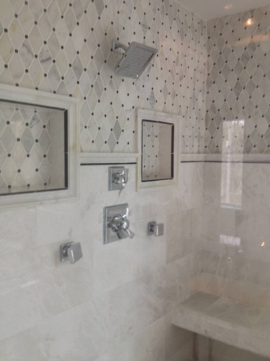Bathroom renovation with custom vanity and tiled shower surround