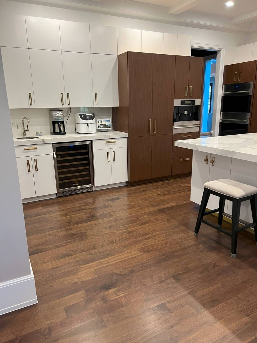 Upscale kitchen renovation with integrated appliances and island seating