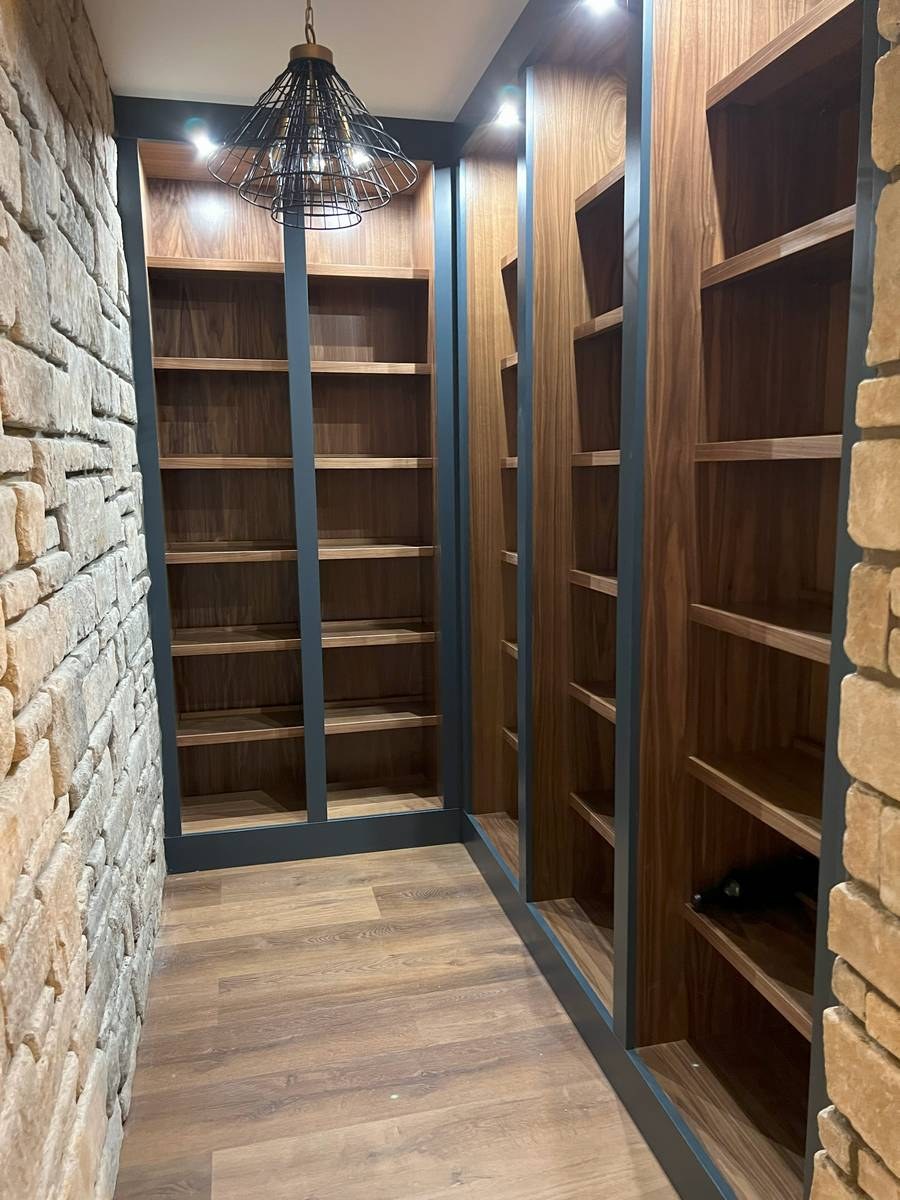 Basement renovation with custom cabinetry, media built-ins, and designer finishes