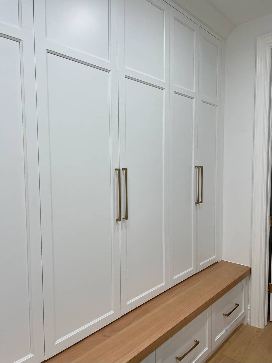 Custom mudroom with built-in cabinetry, cubbies, and organized storage system