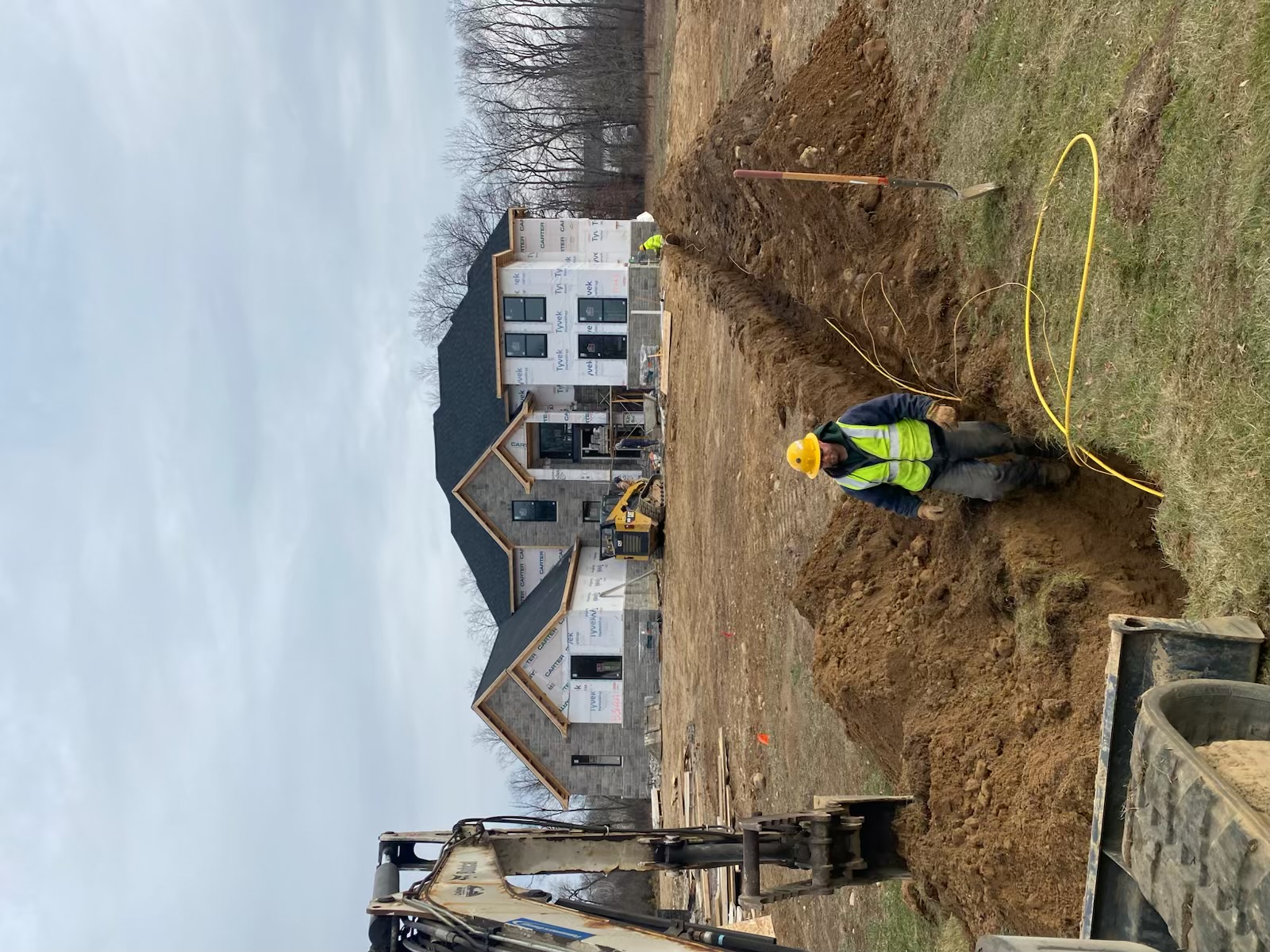 Custom home under construction with scaffolding and framing in progress